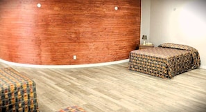 Superior Triple Room (Pet Friendly) | Desk, laptop workspace, blackout drapes, iron/ironing board - Hôtel Val-des-Sources (Val-des-Sources)