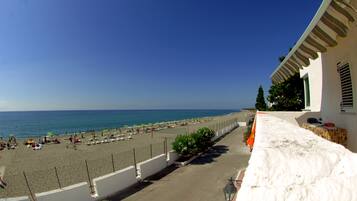 On the beach, sun-loungers, beach umbrellas