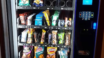 A vending machine stocked with various snacks and condiments.