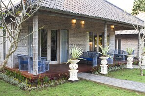 A building with a tiled roof, large windows, and outdoor seating.