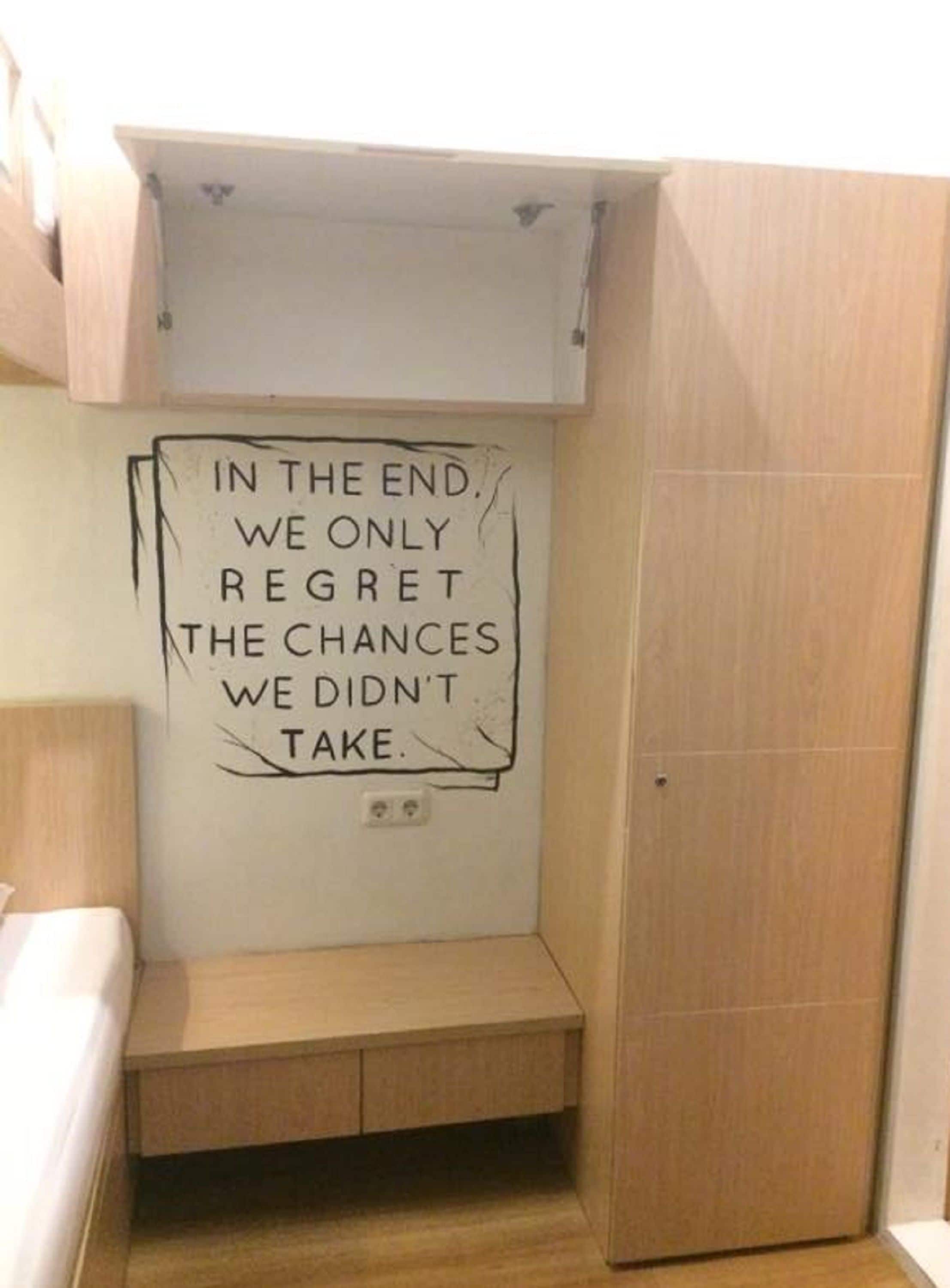 A small, enclosed storage space with a motivational quote on the wall.