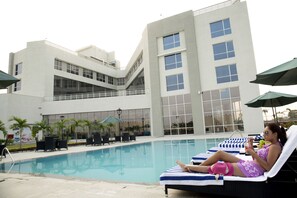 Outdoor pool, open 7:00 AM to 7:00 PM, pool umbrellas