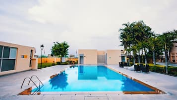 Outdoor pool, open 7:00 AM to 7:00 PM, pool umbrellas