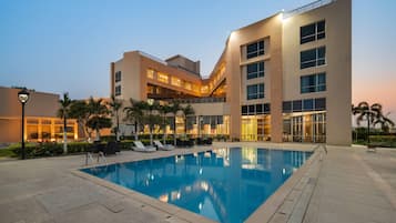 Outdoor pool, open 7:00 AM to 7:00 PM, pool umbrellas