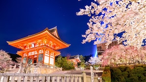 A traditional Japanese building with a tiled roof, surrounded by cherry blossom trees. - Hotel Public Jam (Osaka)