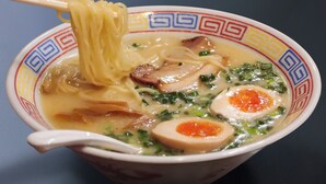 A bowl of ramen with noodles, egg, mushrooms, and greens. - Hotel Public Jam (Osaka)