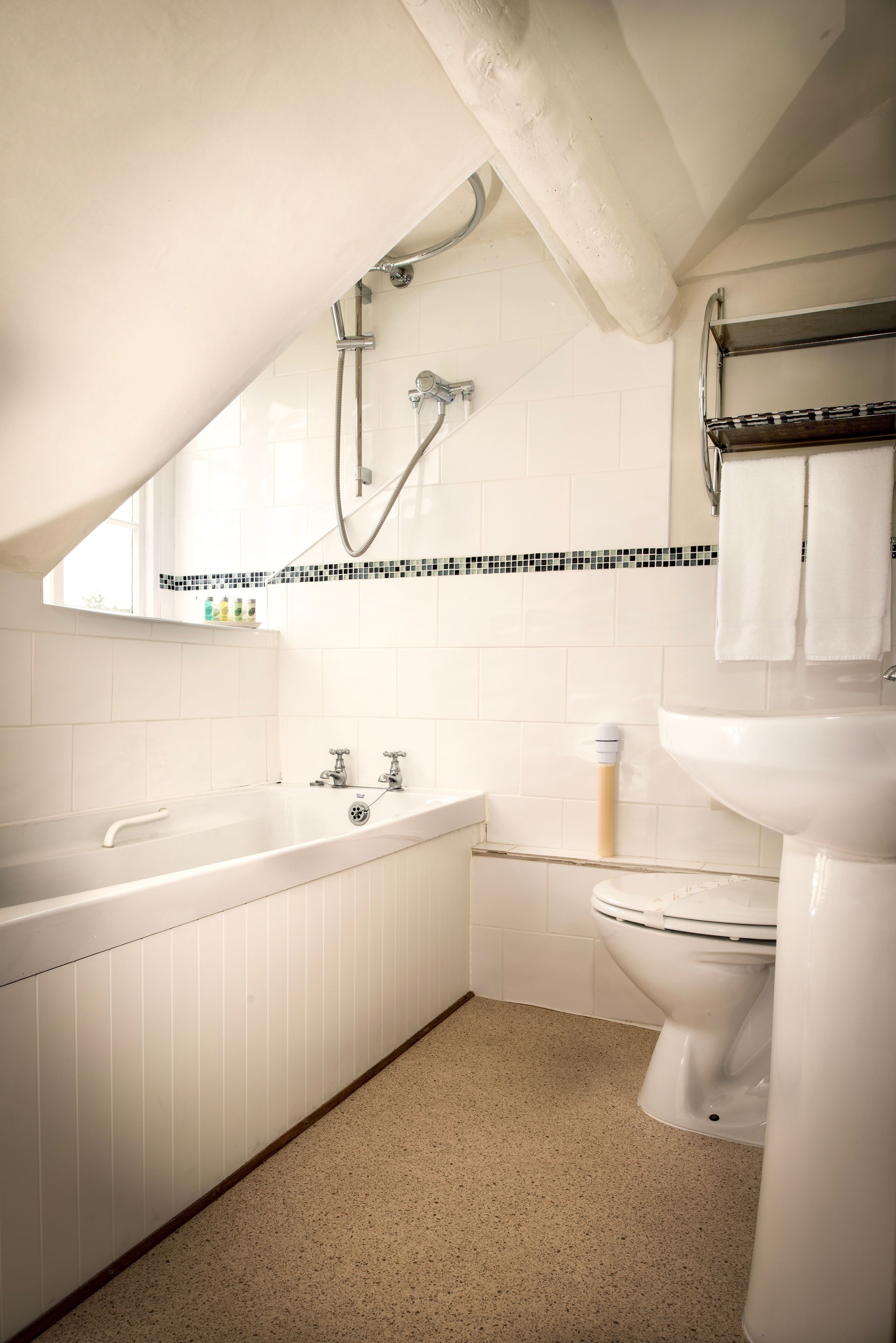 Un baño moderno con una bañera independiente, un inodoro y un lavabo.