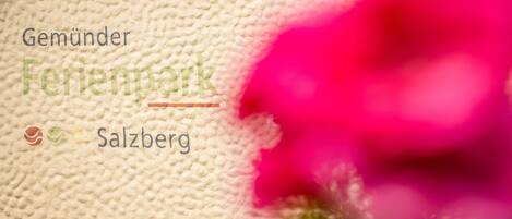 A textured fabric background with the text "Gemünder Ferienpark Salzburg" and a logo.