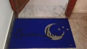 A blue mat with a moon and stars design and the text "Buenos Aires" on a hotel entrance. - B&B BuonaLuna (Palermo)