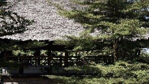 A rustic cabin with a wooden exterior, a porch with chairs, and a small garden area. - House of Love at Pai (Pai)