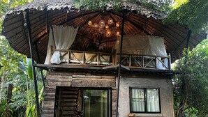 A rustic cabin with a balcony, large windows, and a wooden deck. - House of Love at Pai (Pai)