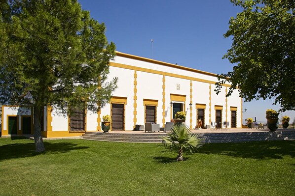 A building with a symmetrical facade, large windows, and a central entrance.