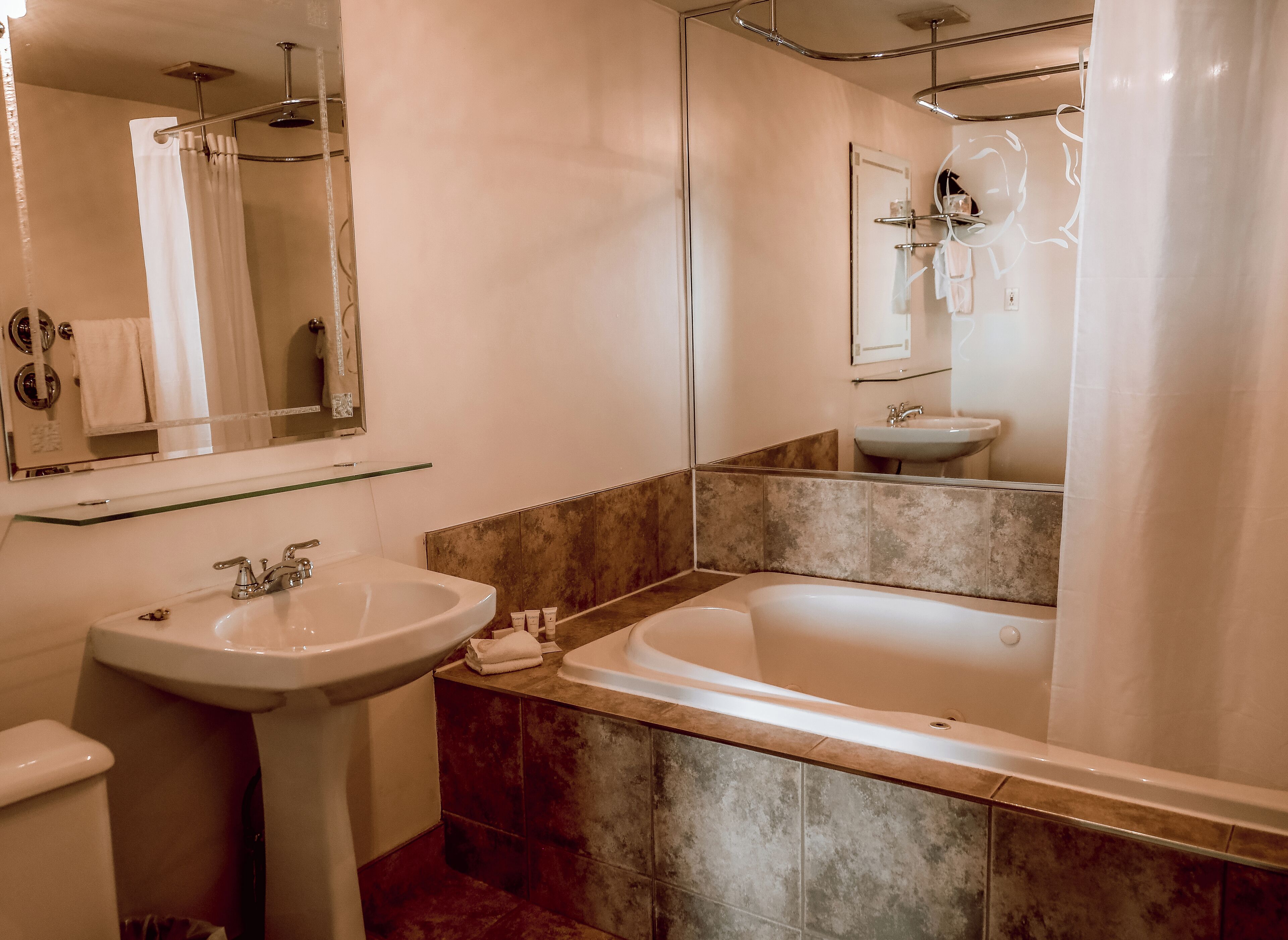 superior room, 1 king bed, whirlpool tub, fireplace, view of the river | bathroom | designer toiletries, hair dryer, towels