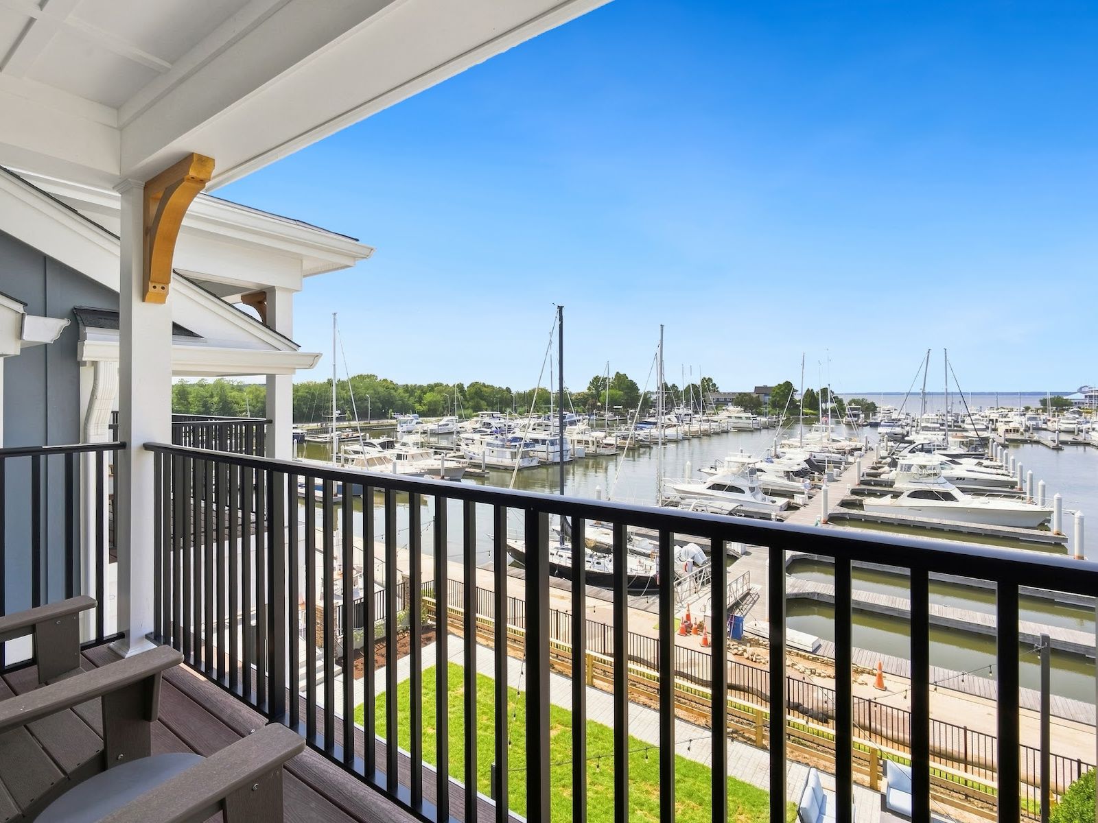 A balcony with a view of a marina filled with boats.