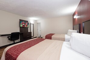 A hotel room with two beds, a TV, a desk, and a chair. - Red Roof Inn Starkville - University (Starkville)