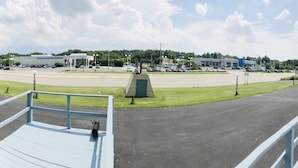 A parking lot with a building labeled "Coca Collision Center" in the background. - Friendly Inn Motel (Harrisburg)