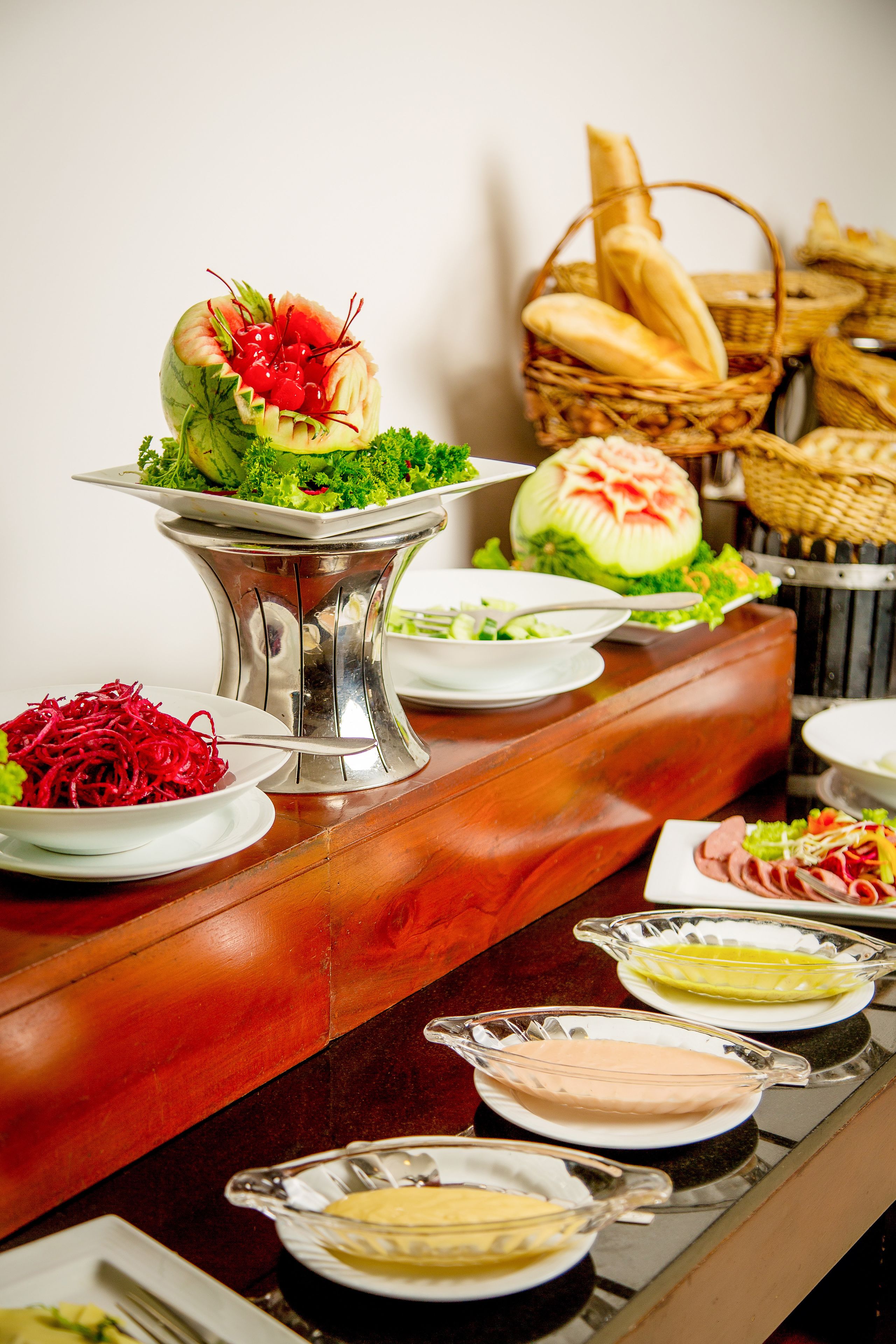 A buffet table with various food items and dishes.