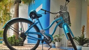 Een blauw fiets geparkeerd op een blauw-wit geruite vloer.