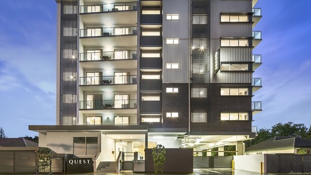 A multi-story hotel with balconies, a well-lit entrance, and a sign reading "QUEST". - Quest Chermside on Playfield (Chermside)