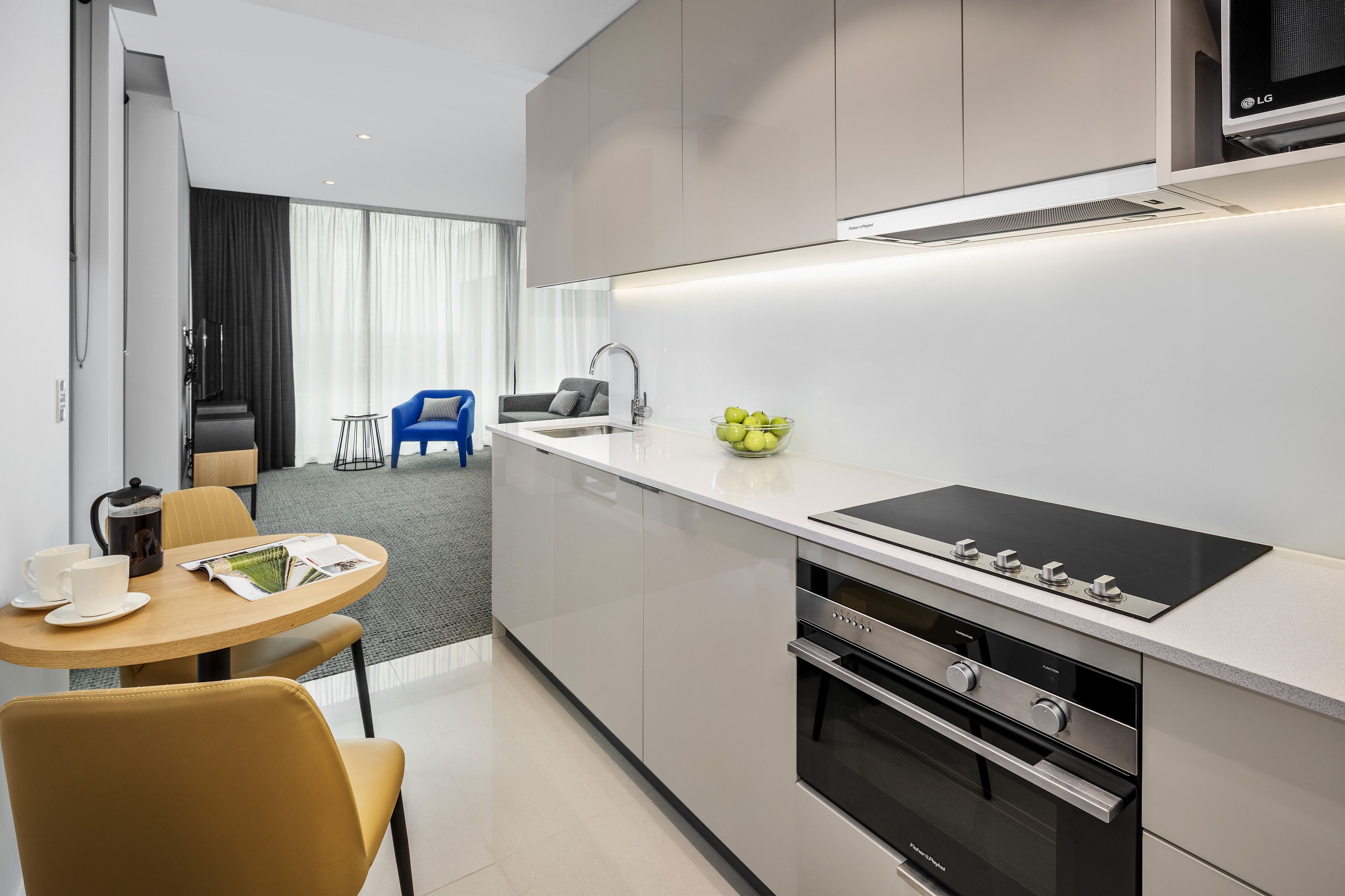 A modern kitchen with a built-in stove, oven, and a large window.