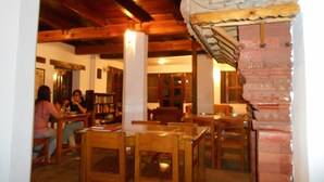 A cozy restaurant with wooden furniture and a traditional architectural design. - Krishna House (Bhaktapur)