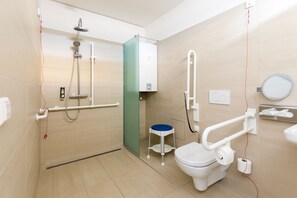 A modern bathroom with a shower, toilet, and handrails. - eeeden apartments Graz (Graz)