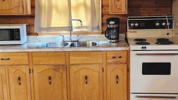 Full-sized fridge, microwave, stovetop, coffee/tea maker