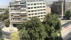 A multi-story building with balconies and a clear view of the surrounding urban area. - Hotel Rex (Thessaloniki)