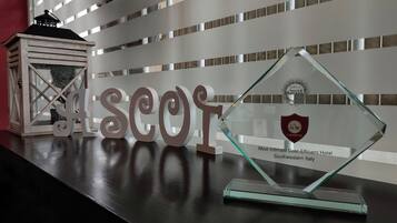 A hotel award plaque on a table with decorative letters spelling "ASCOR".