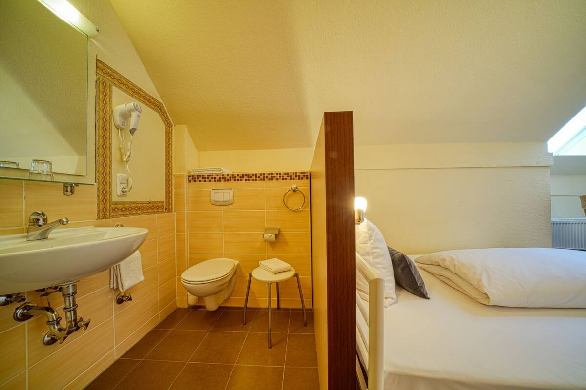 single room | bathroom | shower, hair dryer, towels, soap