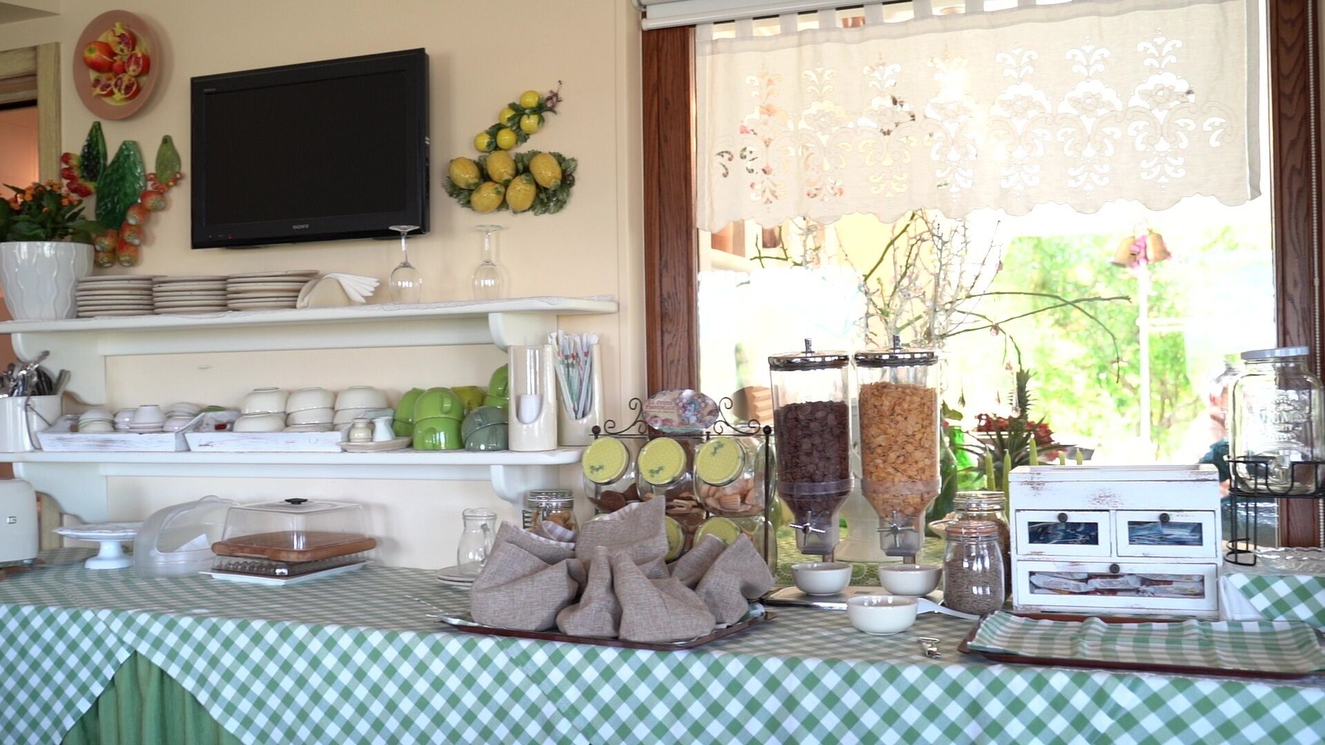 A breakfast buffet setup with various food items and utensils on display.