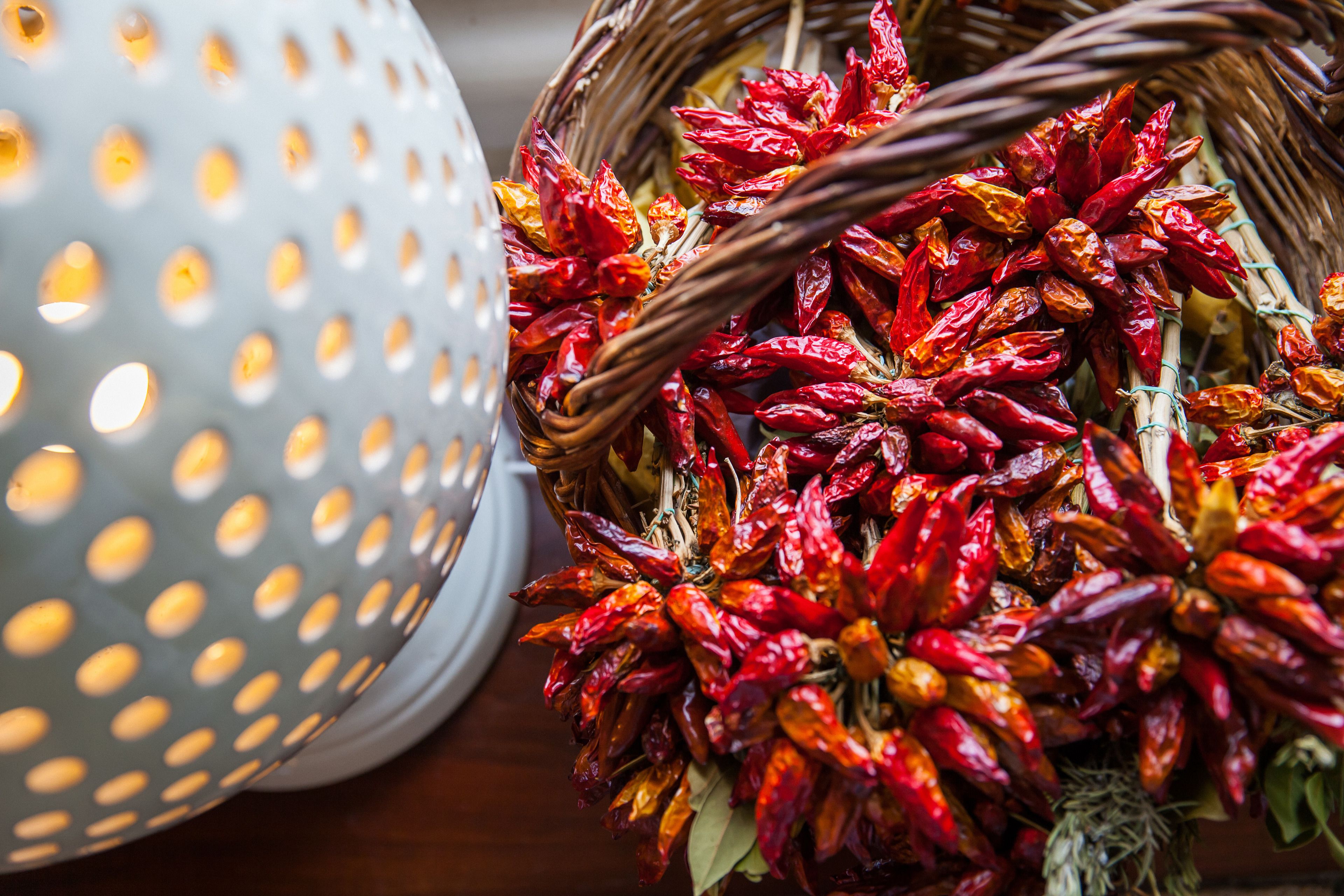 A wicker basket filled with dried red chili peppers.