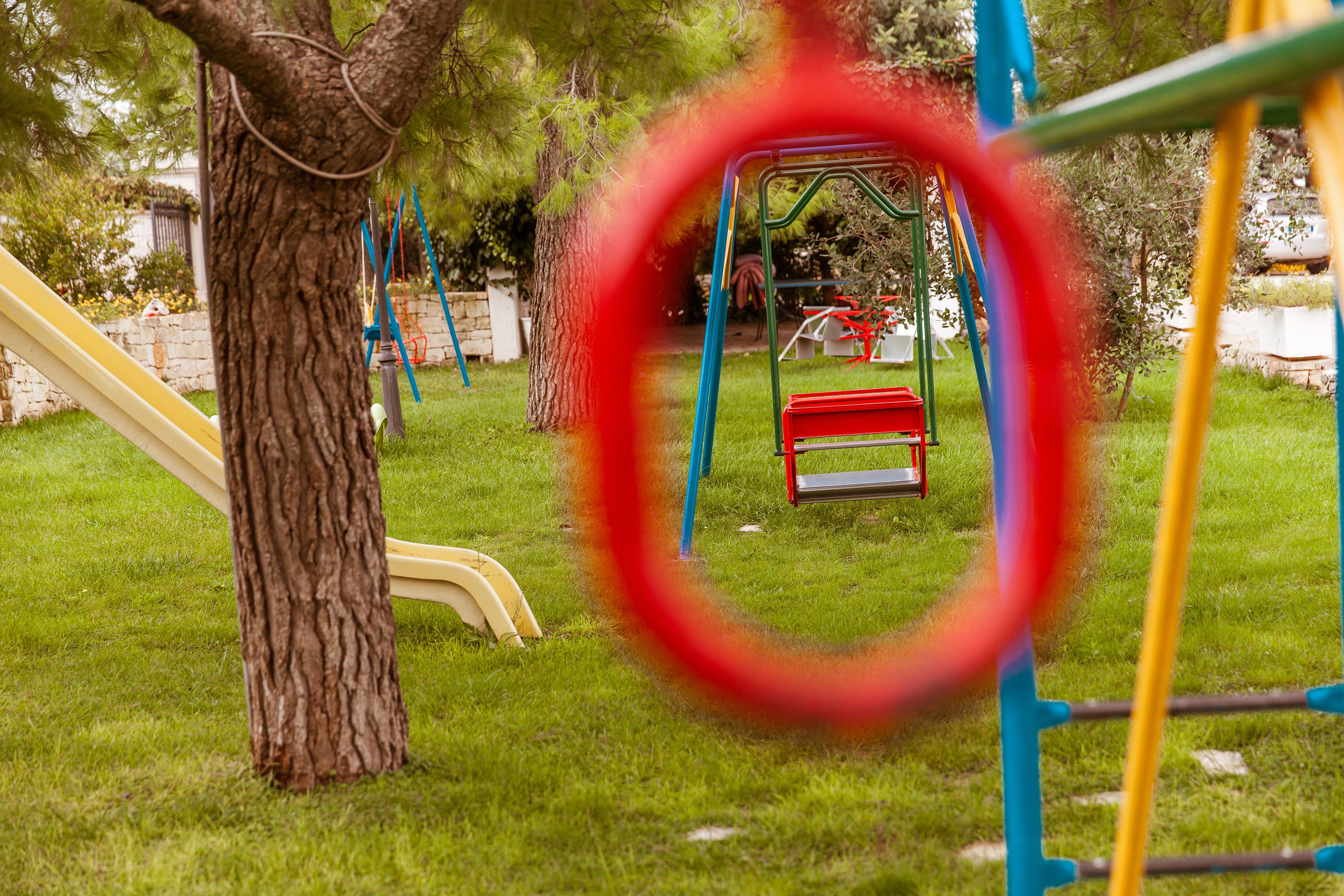 A playground with a swing set and slides.