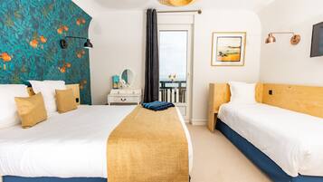 A hotel room with two beds, a large window, a view of the sea, a flat-screen TV, and a painting on the wall.