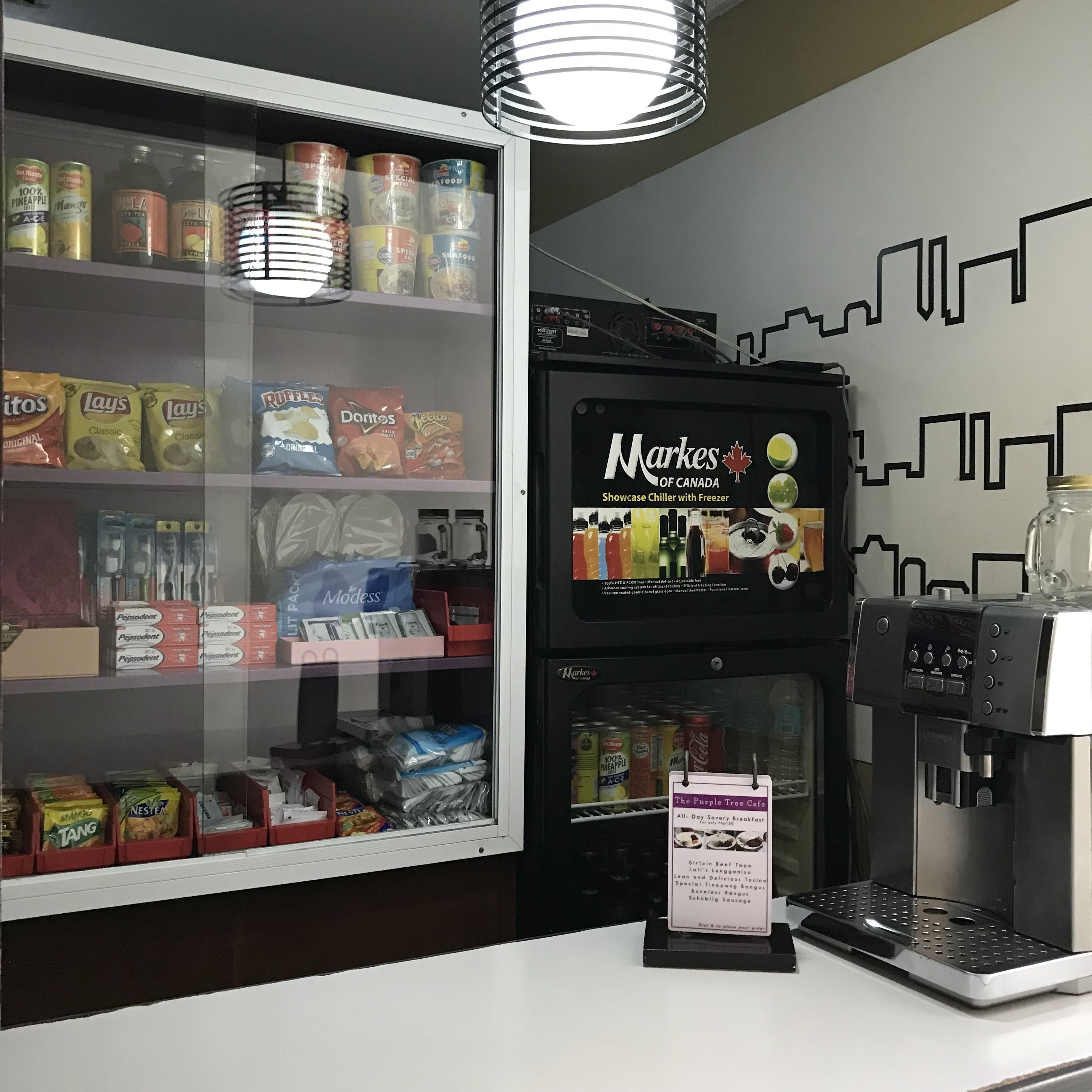 A beverage dispenser with a sign indicating it is a Markes of Canada showcase chiller with freezer.