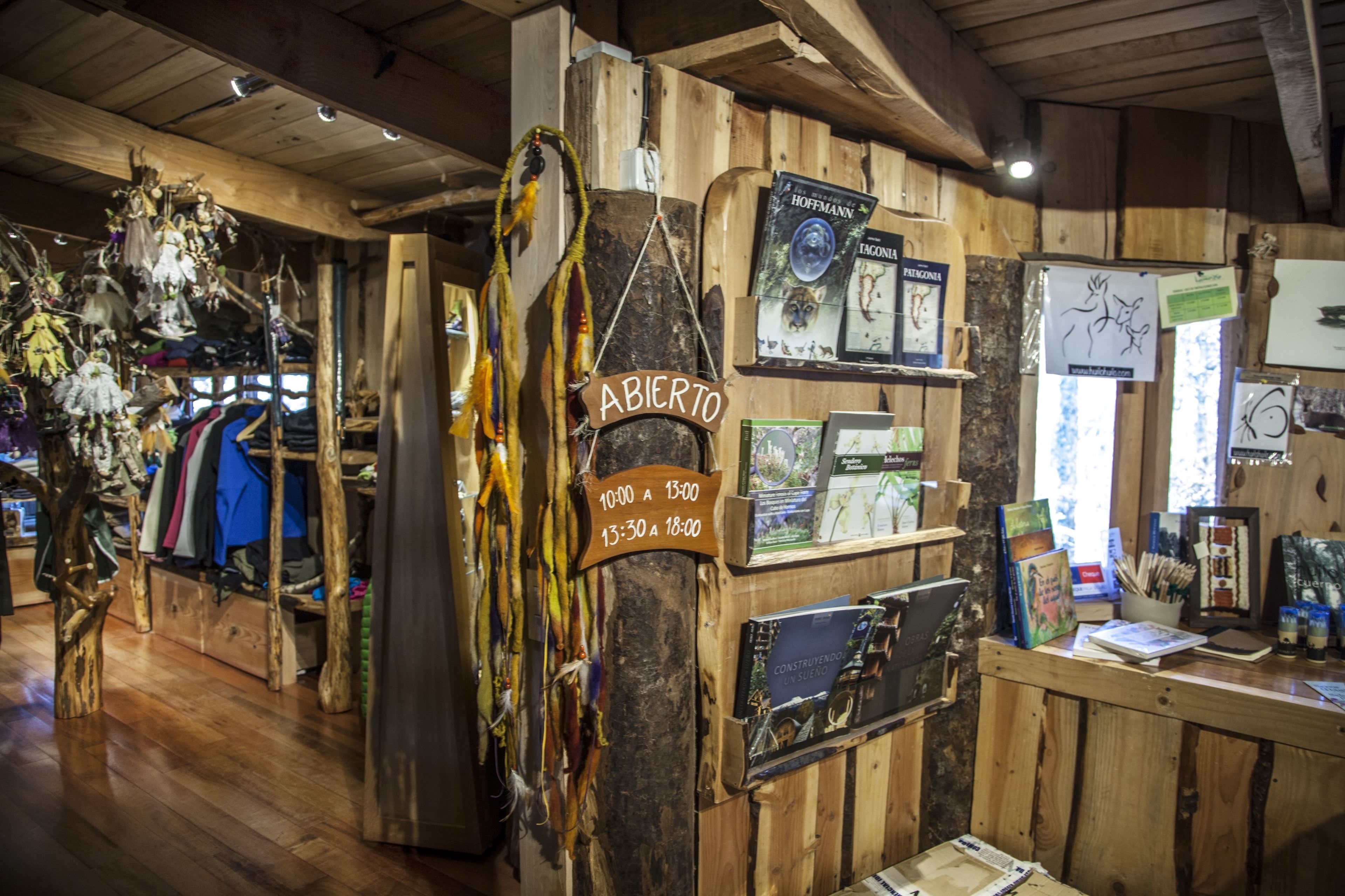 A rustic interior with wooden walls, a sign indicating 'ABICERO' and operating hours, and various items displayed on shelves and counters.