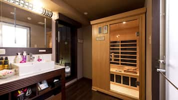 A bathroom with a large mirror, a sink with toiletries, and a wooden cabinet with a towel rack.