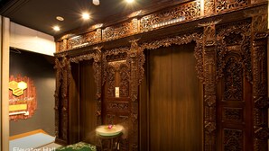 An elevator hall with ornate wooden doors and a small table with a vase. - Pasela no Mori Yokohama Kannai (Yokohama)
