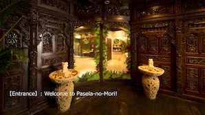 An ornate entrance with intricate woodwork and two decorative pedestals with flowers. - Pasela no Mori Yokohama Kannai (Yokohama)