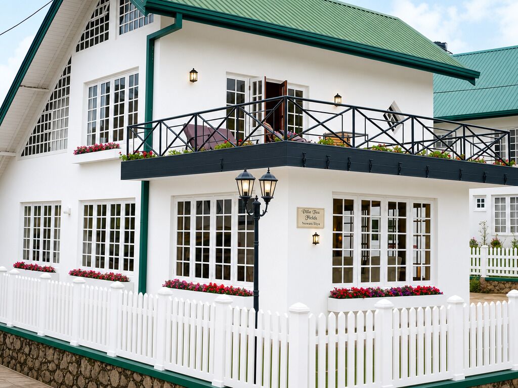 Un edificio blanco con techo verde, un balcón con barandilla y un cartel que dice 'Dille Tea Fields'.