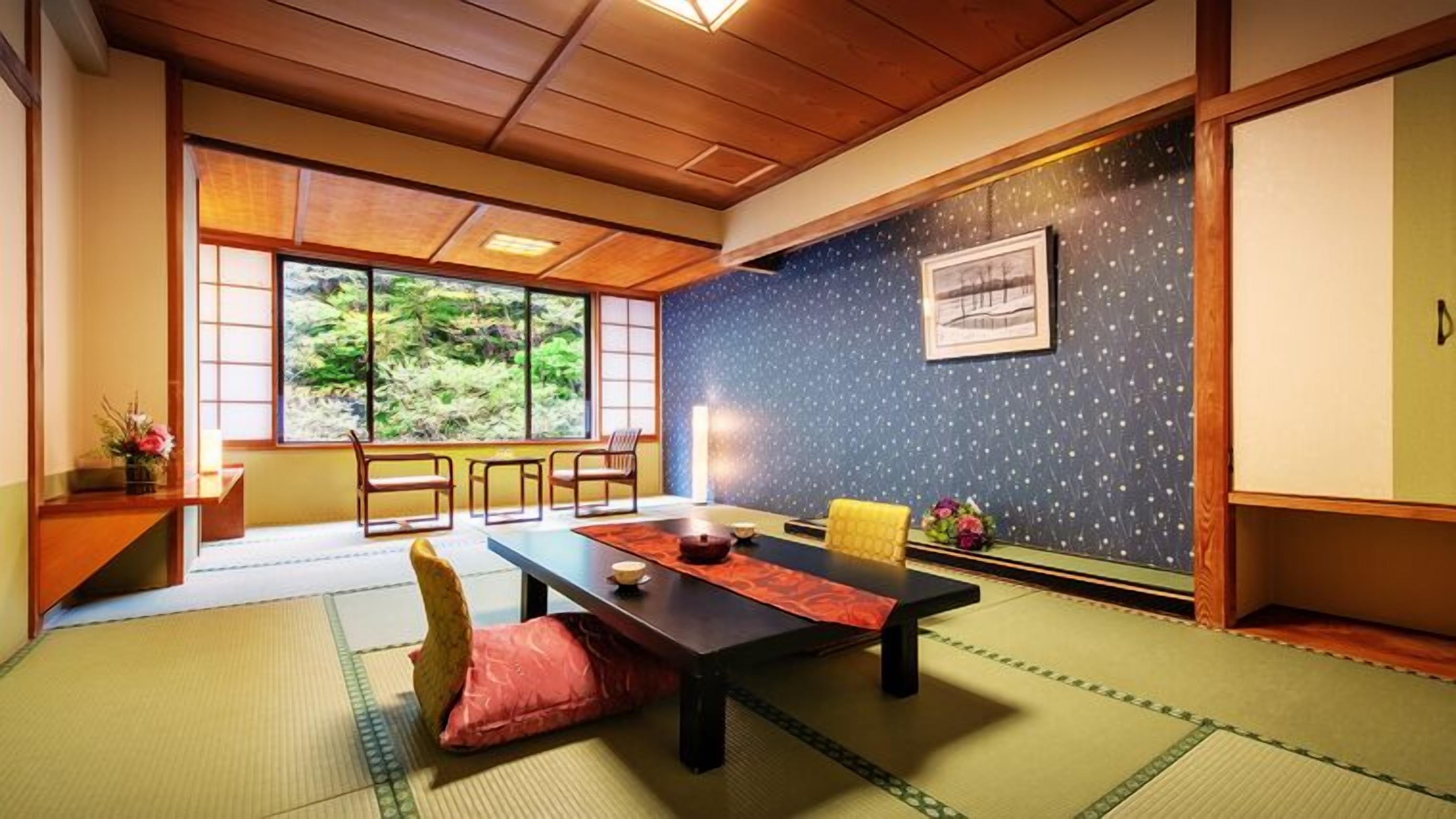 A traditional Japanese room with tatami flooring, a low table, and sliding doors.
