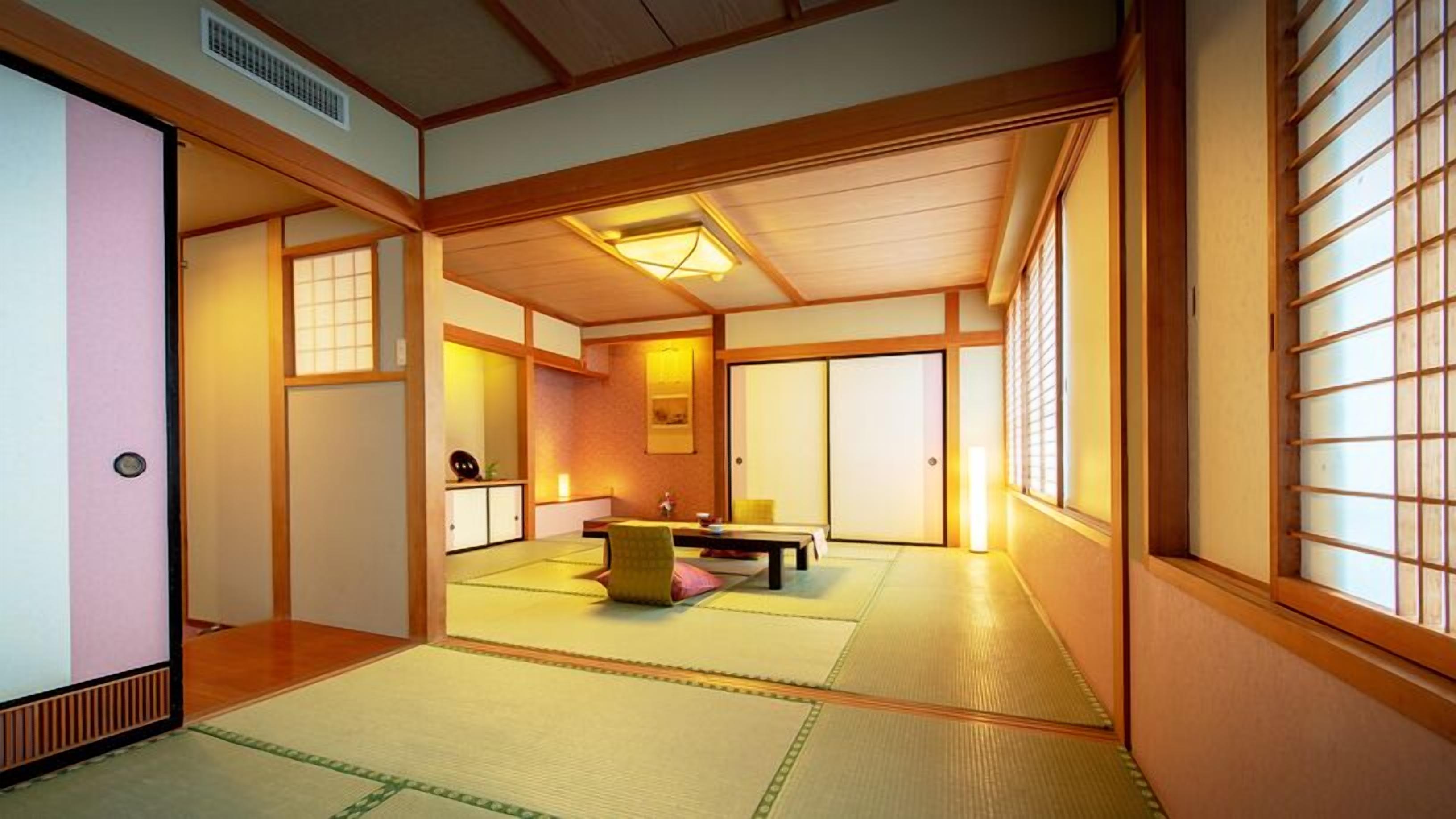 A traditional Japanese room with tatami flooring, sliding doors, and a low ceiling.