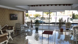 A hotel lobby with a marble floor, ornate furniture, and a large window offering a view of the street. - Zeugma Park Hotel (Istanbul)