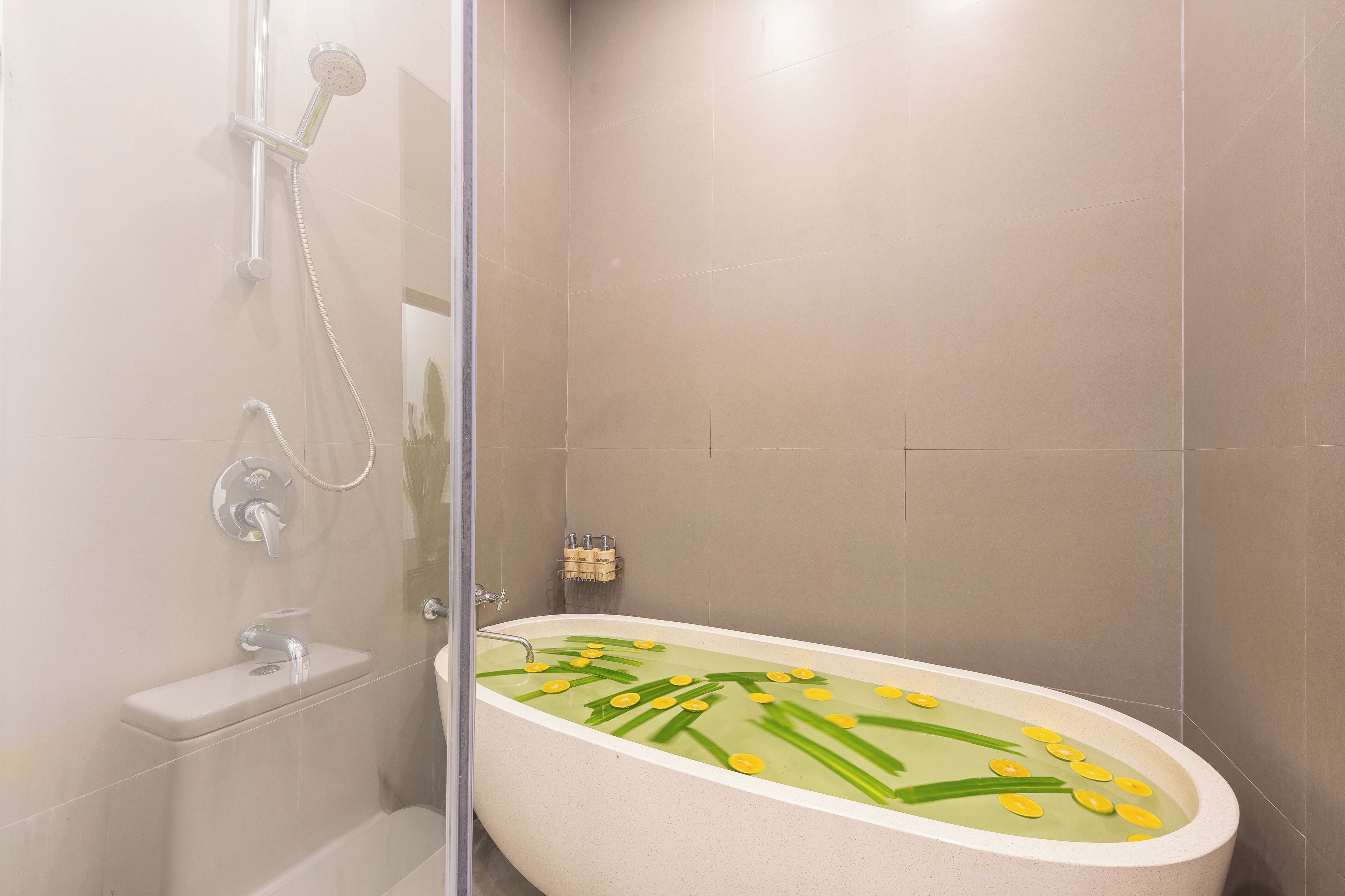 A modern bathroom with a freestanding bathtub, a glass shower enclosure, and a toilet.