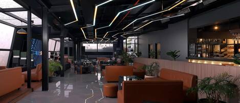 A modern lounge area with orange seating, a bar, and a large digital screen.