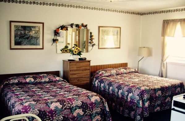 A room with two beds, a dresser, a mirror, and a window with curtains. - Lakeview Motel and Apartments (Massena)