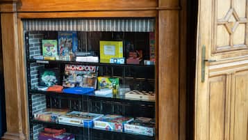 A game shelf with various board games and a Monopoly box.