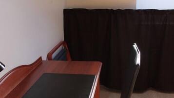 Une petite pièce triangulaire, avec une table en bois et deux chaises.