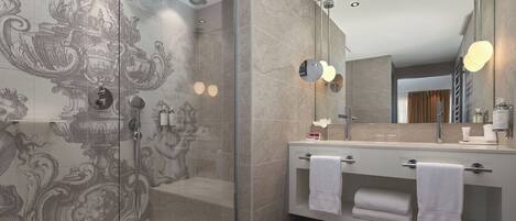 Un baño moderno con ducha envuelta en vidrio, tocador con espejo y azulejos decorativos.