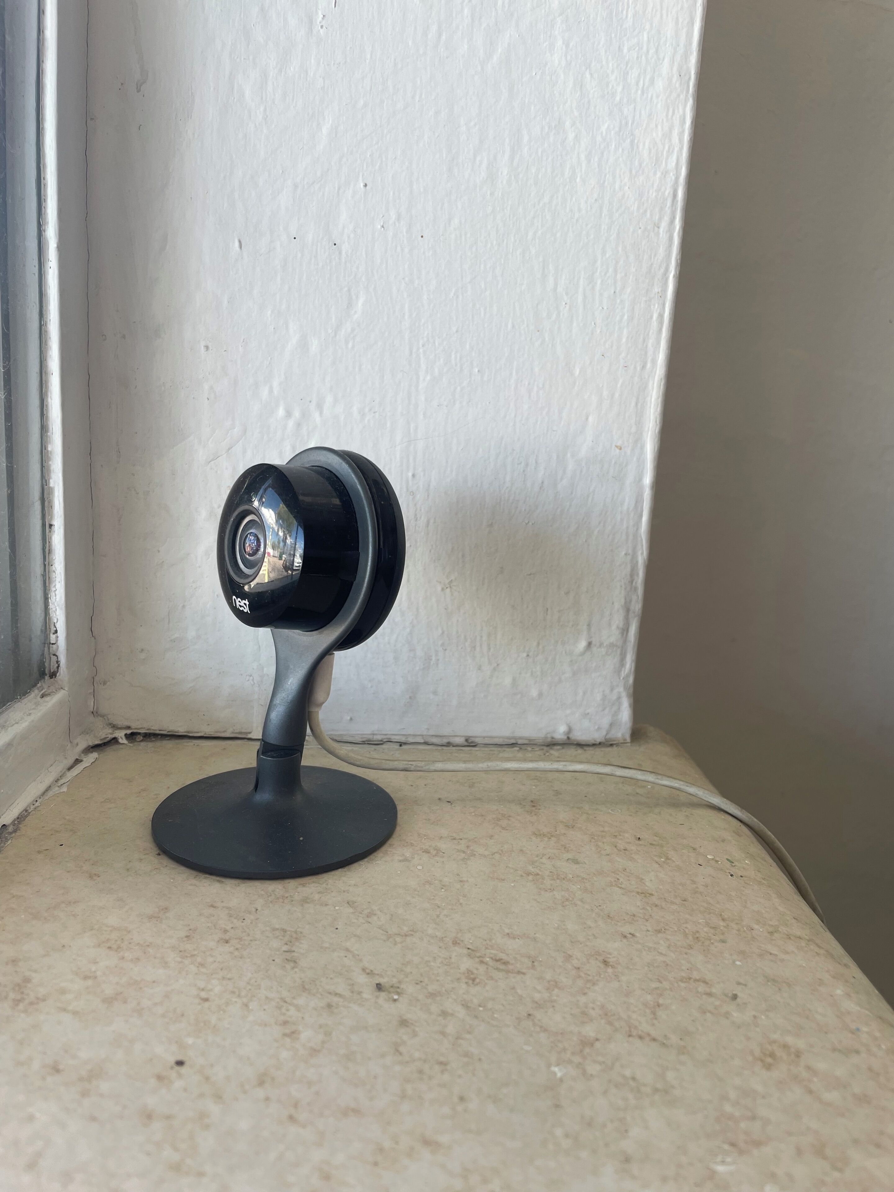 A security camera mounted on a wall corner.